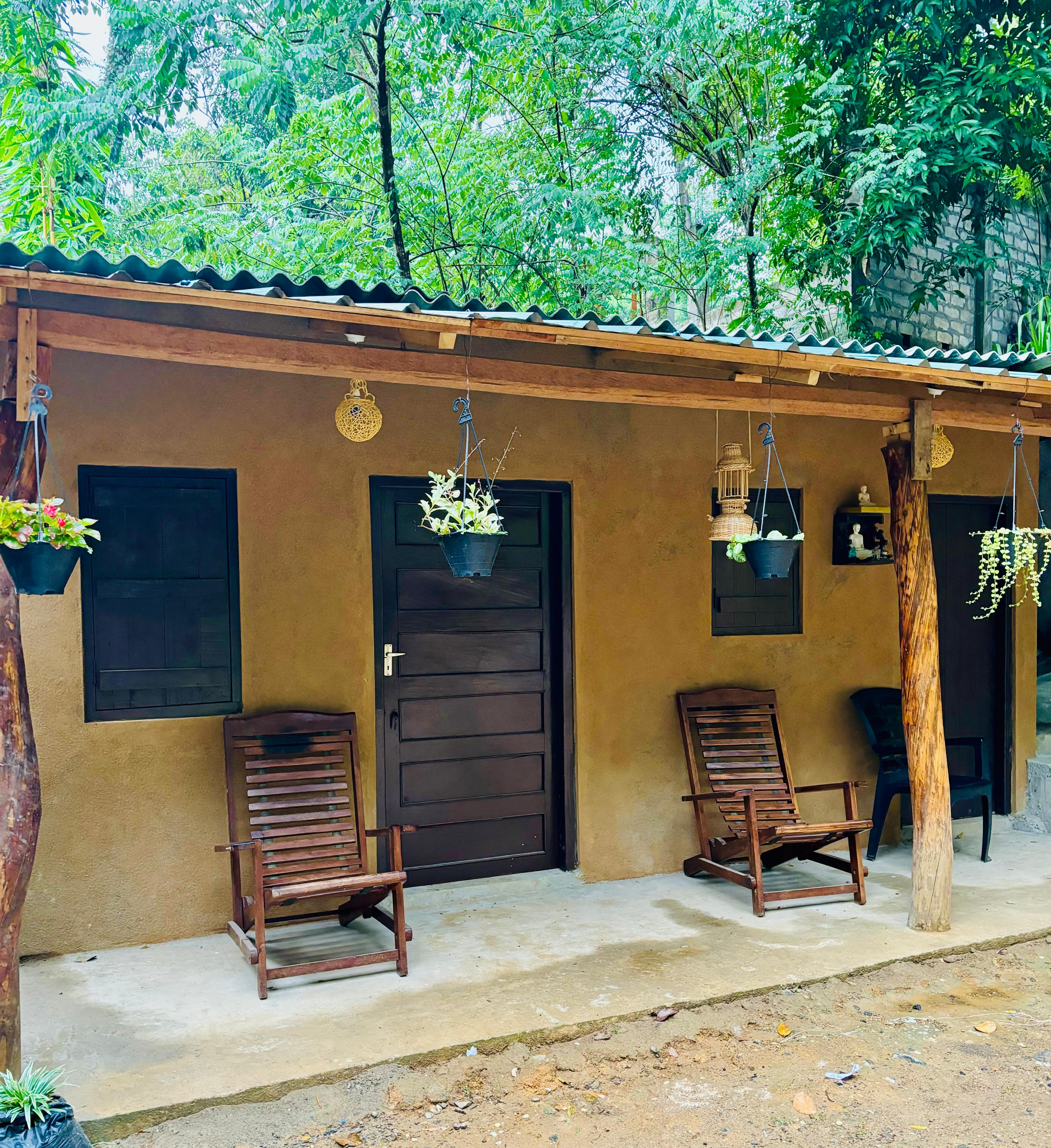 Villa veranda with chairs and hanging plants
